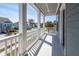 View of front yard from the porch with white railings and columns on a sunny day at 1166 Elliotts Cut Dr, Charleston, SC 29412