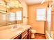 Well-lit bathroom features a vanity with a sink and a mirror, a toilet, and a glass-enclosed shower at 1198 Oakcrest Dr, Charleston, SC 29412