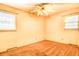 A cozy bedroom featuring a ceiling fan with lighting and natural light from two windows at 1198 Oakcrest Dr, Charleston, SC 29412
