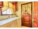 Convenient laundry room with washer, dryer, and cabinet storage near a wooden door at 1198 Oakcrest Dr, Charleston, SC 29412