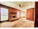 Spacious living room with a brick fireplace, wood paneling, and natural light at 1198 Oakcrest Dr, Charleston, SC 29412