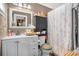 Well-appointed bathroom features modern fixtures, updated vanity, and tiled shower with curtain at 120 Luden Dr # C, Summerville, SC 29483