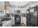 Modern kitchen with stainless steel appliances, mosaic backsplash, a sink, and dark-colored refrigerator at 120 Luden Dr # C, Summerville, SC 29483