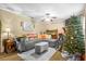 Inviting living room with a gray sofa, area rug, ceiling fan, and festive holiday decorations at 120 Luden Dr # C, Summerville, SC 29483