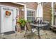 Cozy patio area with table, chairs, umbrella, and potted plants creating an inviting outdoor space at 120 Luden Dr # C, Summerville, SC 29483
