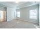 Spacious bedroom with tray ceiling, neutral carpet, large windows offering ample natural light, and fresh paint at 125 Cantona Dr, Summerville, SC 29483