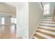 Open entryway with wood stairs and white risers, leading to a bright living space with wood floors at 125 Cantona Dr, Summerville, SC 29483