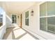Covered front porch provides a shady retreat, accentuated by stylish lighting and a glimpse of the entry door at 125 Cantona Dr, Summerville, SC 29483