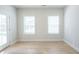 Bright airy room with light wood floors, white walls, two large windows and exterior door at 125 Cantona Dr, Summerville, SC 29483