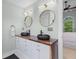 This primary bath features dual vessel sinks, wood counter, and modern lighting at 1324 Southlake Dr, Mount Pleasant, SC 29464