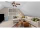 Spacious bonus room offers comfortable seating and a mini fridge at 1324 Southlake Dr, Mount Pleasant, SC 29464