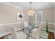 Sophisticated dining room with a glass table, stylish chairs, and elegant chandelier at 1324 Southlake Dr, Mount Pleasant, SC 29464