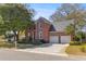 Classic two-story brick home showcasing a well-kept lawn and a two-car attached garage at 1324 Southlake Dr, Mount Pleasant, SC 29464