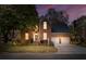 Charming brick home featuring a well-manicured lawn and two-car garage at dusk at 1324 Southlake Dr, Mount Pleasant, SC 29464