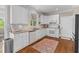 Well-lit kitchen featuring white cabinets, granite countertops, stainless-steel appliances, and hardwood floors at 1324 Southlake Dr, Mount Pleasant, SC 29464