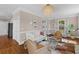 Bright living room features a fireplace, white sofa, hardwood floors, and glass coffee table at 1324 Southlake Dr, Mount Pleasant, SC 29464
