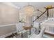 Bright and airy living room showcasing hardwood floors, a staircase, and designer lighting at 1324 Southlake Dr, Mount Pleasant, SC 29464