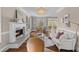 Cozy living room featuring a fireplace, hardwood floors, white couches, and a stylish chandelier at 1324 Southlake Dr, Mount Pleasant, SC 29464