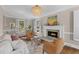 Cozy living room featuring a fireplace, hardwood floors, white couches, and a stylish chandelier at 1324 Southlake Dr, Mount Pleasant, SC 29464