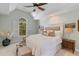 This main bedroom is bright and airy and features a high ceiling with fan and attractive arched window at 1324 Southlake Dr, Mount Pleasant, SC 29464