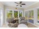 Bright sunroom features large windows offering backyard views and comfortable armchairs at 1324 Southlake Dr, Mount Pleasant, SC 29464