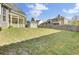 Expansive backyard featuring a lush lawn, privacy fence, shed, and a covered patio, offering ample space for outdoor enjoyment at 136 Rosario Dr, Summerville, SC 29483