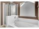 Bathroom showcasing a bathtub with glass shower doors and a bright window providing natural light at 136 Rosario Dr, Summerville, SC 29483