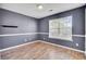 Cozy bedroom featuring chair rail detail, wood-look flooring and a large window for natural light at 136 Rosario Dr, Summerville, SC 29483