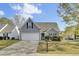 Charming home featuring a two-car garage, grey siding, manicured bushes, and a well-maintained lawn at 136 Rosario Dr, Summerville, SC 29483