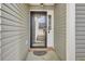 A well-lit front porch with an ornate door mat and a screen door with glass panes at 136 Rosario Dr, Summerville, SC 29483