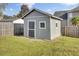 Backyard shed with gray siding and black door at 136 Rosario Dr, Summerville, SC 29483