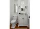 Elegant powder room with white fixtures, stylish lighting, and classic design elements at 14 Greenhill St, Charleston, SC 29401