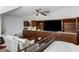 Bedroom with kitchenette, large flat screen TV, white sofa and hardwood floors at 14 Greenhill St, Charleston, SC 29401