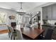 Elegant dining room with a large table, decorative lighting, and staircase leading to the upper level at 14 Greenhill St, Charleston, SC 29401