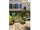 Inviting front entrance with a curved stairway, decorative flower pots, and lush greenery at 14 Greenhill St, Charleston, SC 29401