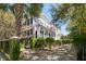 Beautiful two-story house with a charming porch, American flag, and well-manicured greenery and walkway at 14 Greenhill St, Charleston, SC 29401