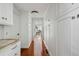 Hallway featuring custom built-in cabinets, hardwood floors, and access to the living area at 14 Greenhill St, Charleston, SC 29401