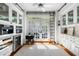 Sun-filled kitchen area with access to the backyard, sleek white cabinets, and wine storage at 14 Greenhill St, Charleston, SC 29401