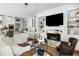 Cozy living room with built-in shelving, marble fireplace, and open access to the kitchen at 14 Greenhill St, Charleston, SC 29401