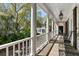 Spacious porch showcasing stately columns, a wooden floor, and a view of lush landscaping at 14 Greenhill St, Charleston, SC 29401