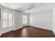 Room with white walls, wood-look flooring, board and batten trim and plantation shutters at 14 Greenhill St, Charleston, SC 29401
