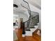 Elegant interior staircase with dark wood railings, light gray carpet, and classic architectural details at 14 Greenhill St, Charleston, SC 29401