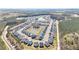 Scenic aerial view of a vibrant community featuring lush landscaping, well-maintained homes, and a tranquil pond at 1427 Homecoming Blvd, Ravenel, SC 29470