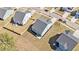 Aerial view of new home with spacious backyard and patio, surrounded by other well-manicured properties at 1427 Homecoming Blvd, Ravenel, SC 29470