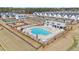 Aerial view of community pool and playground, surrounded by well-manicured lawns and new construction homes at 1427 Homecoming Blvd, Ravenel, SC 29470