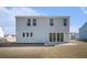 Back exterior view of two story home, showcasing the large backyard and sliding glass doors at 1427 Homecoming Blvd, Ravenel, SC 29470