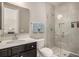 Modern bathroom offers glass-enclosed shower, granite countertop, and stylish mirror at 1427 Homecoming Blvd, Ravenel, SC 29470