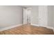 A bedroom with wood-look floors and a doorway to an en-suite bathroom at 1427 Homecoming Blvd, Ravenel, SC 29470