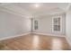 This bedroom features hardwood floors, bright windows, and detailed trim and moulding at 1427 Homecoming Blvd, Ravenel, SC 29470
