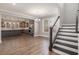 Open dining area with hardwood floors, a view of the kitchen, and natural light at 1427 Homecoming Blvd, Ravenel, SC 29470